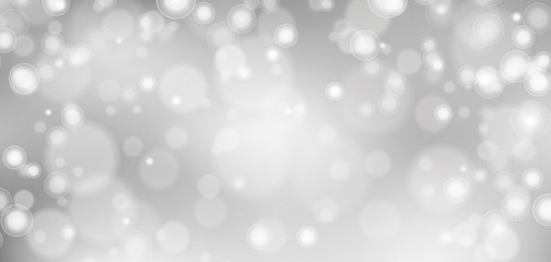 Obraz na płótnie Canvas Silver bokeh background. Christmas glowing lights with sparkles. Holiday decorative effect.