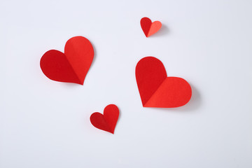 Red paper hearts on white background