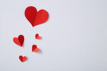 Red paper hearts on white background