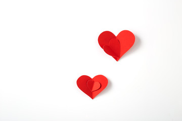 Red paper hearts on white background