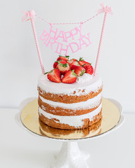 Happy birthday fresh fruit strawberry cake with Happy birthday tag on cake concept,Strawberry fruit cake. Food concept.