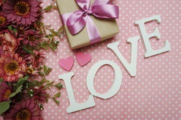 Love word alphabet and roses bouquet with space copy on pink polka dot background