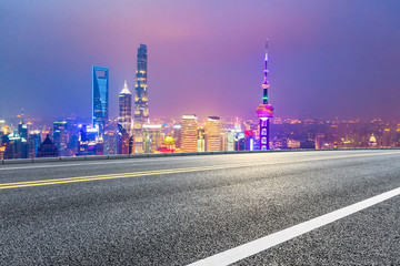 Fototapeta na wymiar Asphalt highway and beautiful cityscape in Shanghai at night.