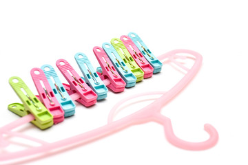 Clothing tweezers with coat hanger isolated on white background