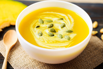 Pumpkin soup with pumpkin seed and cream in a bowl