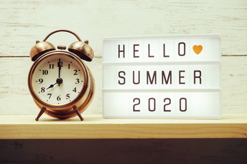 Hellow Summer text in lightbox on wooden background