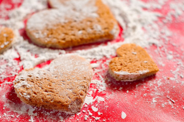 Valentine's red background decorative, Heart shape cookies and white icing flour, Valentine's day gift bakery concept for card or creative design.