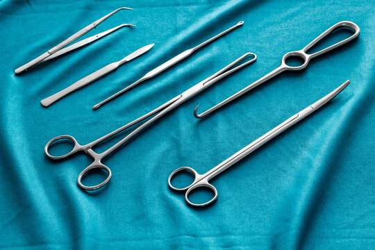 Instruments for plastic surgery on blue background flat lay pattern