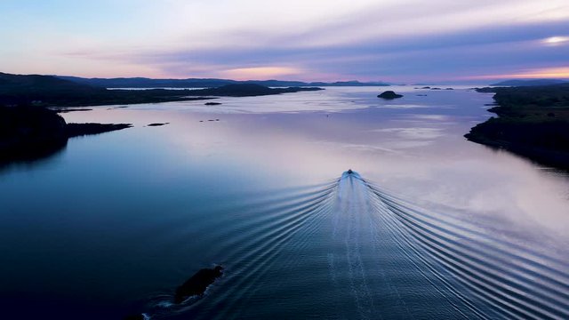 aerial footage of loch linnhe at port appin on the west coast of scotland in the argyll region of the highlands near oban and fort william on a pink sunset evening in winter with calm seas