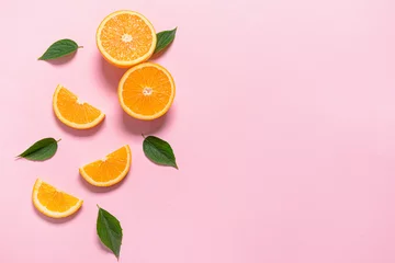 Fotobehang Fresh orange pieces on color background © Pixel-Shot