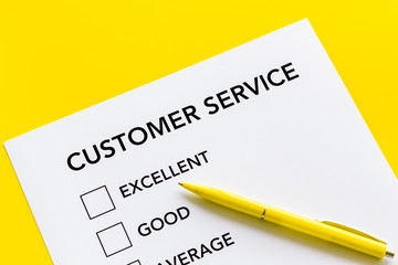Obraz premium Customer service form with mark Exellent close up on yellow background top view