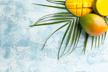 Tasty mango fruit on color background