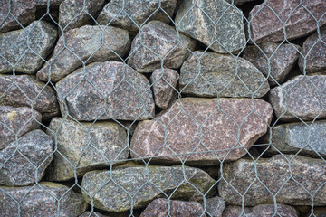 stones and pebbles wall in wire mesh