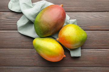 Tasty mango fruit on wooden background