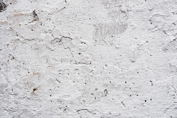 Texture of a concrete wall with cracks and scratches which can be used as a background
