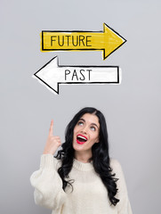 Future or past with happy young woman on a gray background