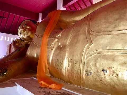 Ancient biggest reclining buddha (posture sleep) Lanna style at Northern Thailand temple