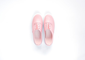 One pair of pink casual shoe for woman on isolated white background for poster, advertising or any issue about fashion.