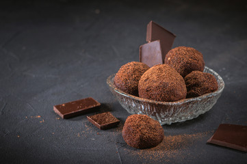 Small chocolate potato cake on dark background