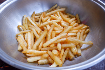 French fries in stainless bowl.