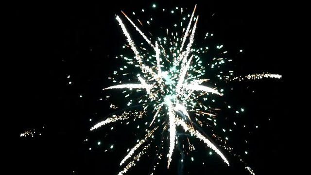 Explosion of bright colorful part of fireworks on black background to create a set salute on video for holiday new year, birthday, wedding or other celebration.