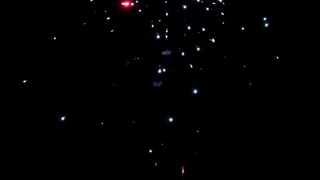 Explosion of bright colorful part of fireworks on black background to create a set salute on video for holiday new year, birthday, wedding or other celebration.