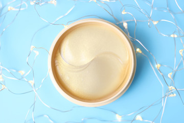 Transparent patches under in a round jar on blue background with bokeh top view