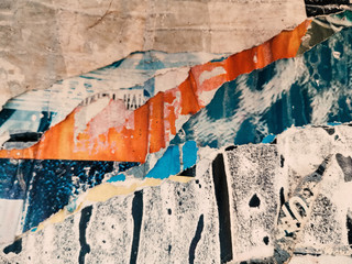 Fototapeta premium Layers of vintage posters glued and torn with time to the wall