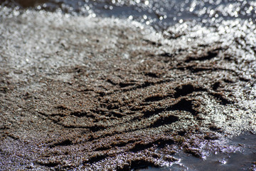 Fototapeta na wymiar Wet dirt with tire marks on the road