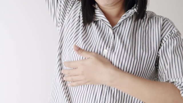  Hand of  adult woman examine her breast on white background. The concept of breast cancer prevention