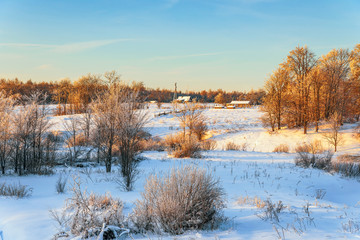 Rural landscape at sunset in winter.Novgorod oblast.Russia