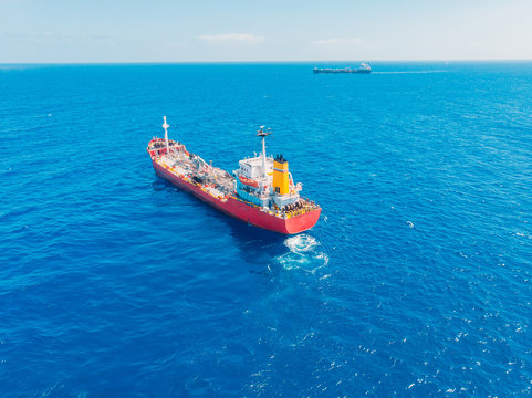 Oil chemical tanker sails blue sea. Aerial top view