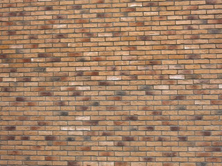 texture of beige or brown brick wall with colored bricks