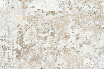 Old cracked and peeled white concrete wall. 