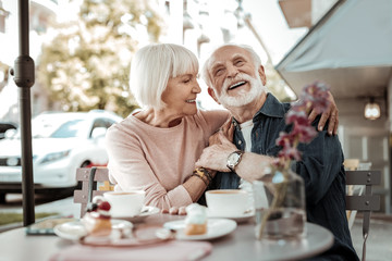 Nice happy couple sitting together in the cafe