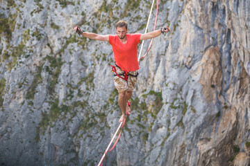 A man walks confidently along the highline.