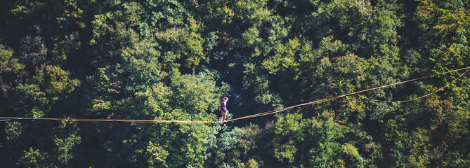 A man walks confidently along the highline.