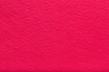 Fine grain coral red woolen felt. Texture background. Velvet scarlet matte background of suede fabric.