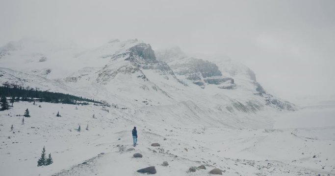 Young Woman Walks Along Rocky Ridge at Athabasca Glacier in Jasper National Park Alberta Canada