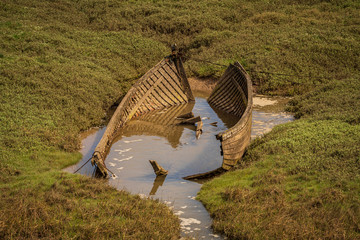 The wreck of a boat in the grass, seen in Askam-in-Furness, Cumbria, England, UK