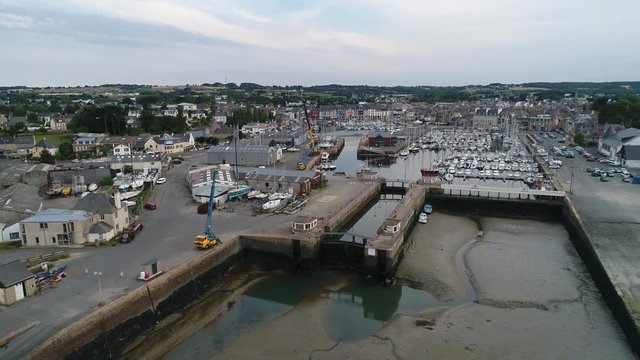 Aerial view. Gateway and moorage for boats and yachts in the Marina closed at low tide in the town of Paimpol in Northern France, in Brittany.