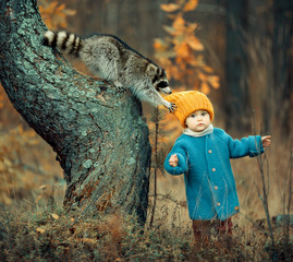 Girl and raccoon in autumn forest