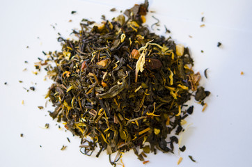 Green tea with additives closeup on white background. Proper nutrition, healthy tonic drink.