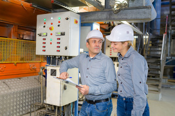 workers operating machinery in factory