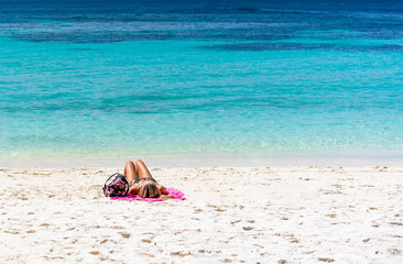 Fototapeta na wymiar Woman sunbathe on beach an Lipeh Satun Thailand