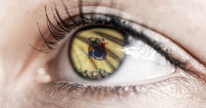 Woman Green Eye In Close Up With The Flag Of New Jersey State In Iris, United States Of America With Wind Motion. Video Concept