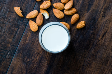 Obraz na płótnie Canvas Almond Milk in Glass Cups with Almonds and Fabric Cloth.