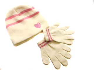 Hat and gloves isolated on white background. Composition of gloves and a hat for the girl. Children's clothing for winter.