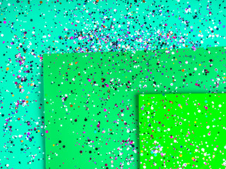 Paper sheets in mixed green colors with holographic foil confetti. Trendy mint and green abstract...
