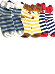 Set of socks isolated on a white background. Composition of multi-colored socks. Children's socks. Socks background.